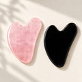 Pink and black gua sha facial massage stone pair